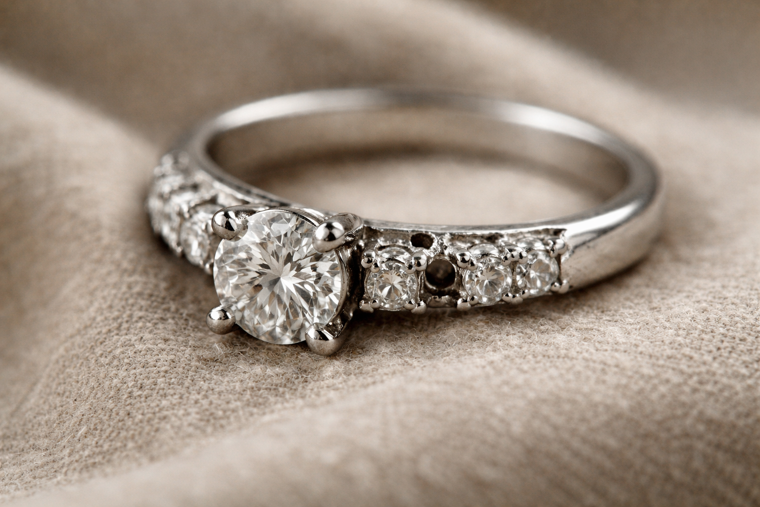 Stone-set platinum ring with missing small diamond and worn claws